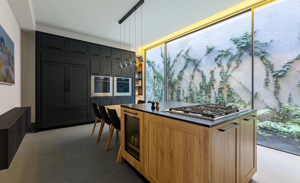 Luxury kitchen within the Sub-Zero, Wolf, and Cove showroom in Mexico City featuring black cabinets and a view outside.