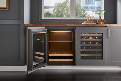 Interior view of handleless Sub-Zero 24" Designer Undercounter ADA Height Beverage Center - Panel Ready (DEU2450BG/ADA) shown in black custom cabinetry