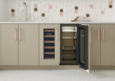 Interior view of Sub-Zero 15" Designer Undercounter Beverage Center - Panel Ready (DEU2450BG) shown in a row of tan custom cabinets