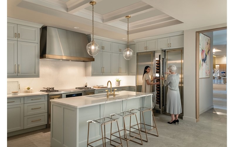Customers exploring Wolf Ovens during an in person product demonstration at a local Sub-Zero, Wolf, and Cove Kitchen Appliances Showroom