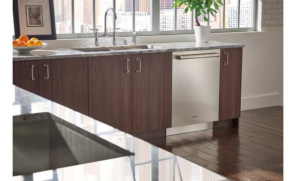 Stainless Steel Cove Dishwasher with Pro Handle (DW2450) installed in Brizo kitchen featuring natural wood tone cabinets.