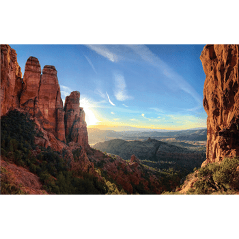 Energy vortexes can be found throughout the world, like this energetic sunrise behind a cascading rock formation.