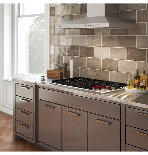 La placa de cocción de gas profesional de 36" Wolf (CG365P/S) y la campana extractora de pared de 36" Wolf - Inoxidable (VW36S) en un elegante diseño de cocina