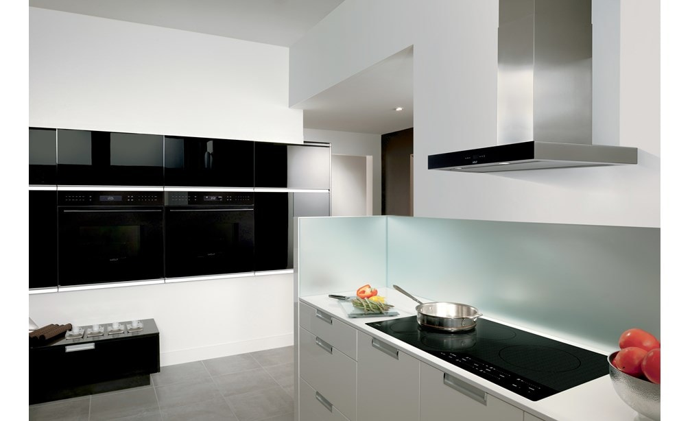 Placa de inducción contemporánea de 36" Wolf (CI365C/B) exhibida con campana extractora de pared de 36" negra (VW36B) que brilla en un diseño de pulcro y elegante