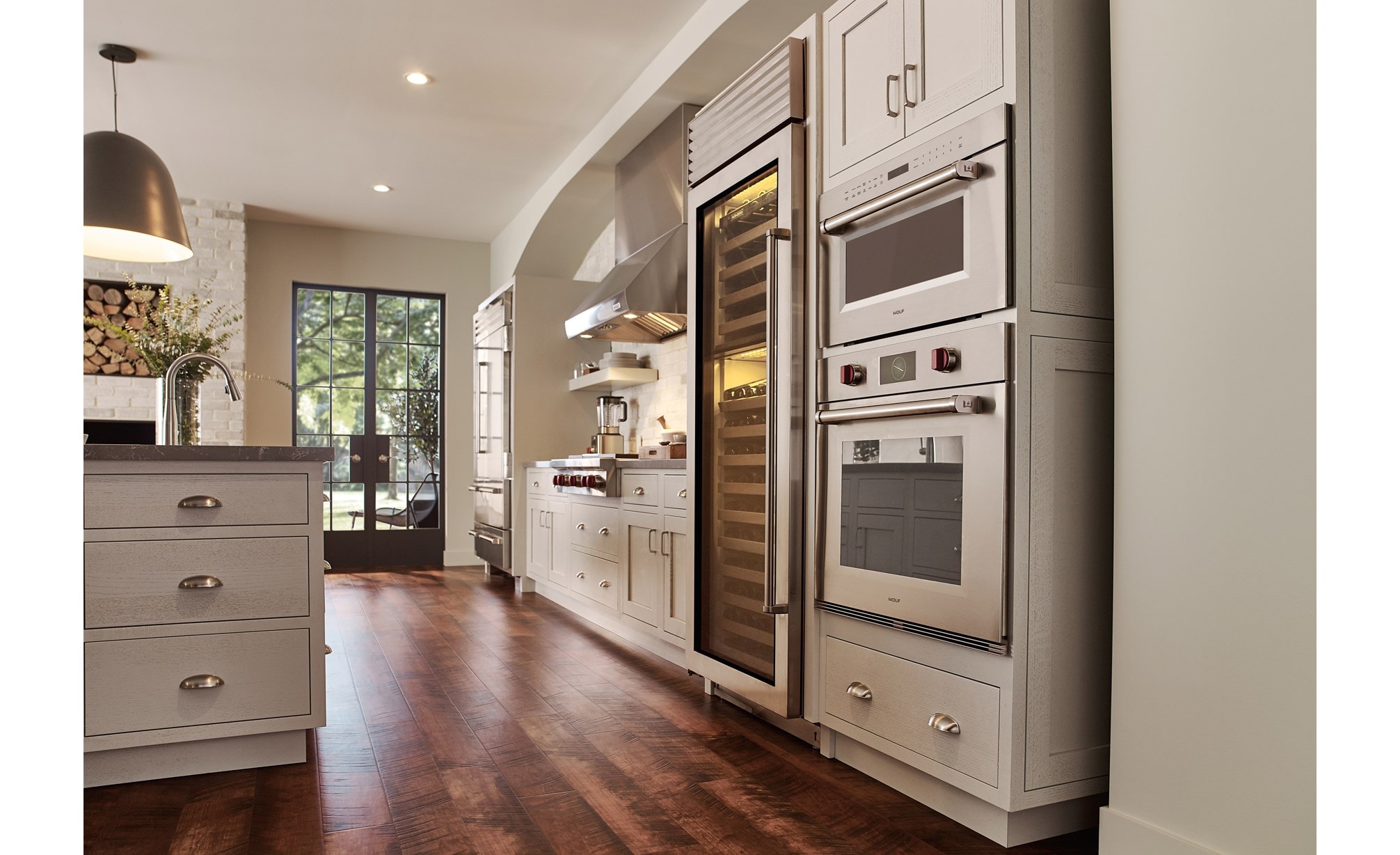 Horno microondas con puerta abatible profesional de 30" Wolf de la serie M (MDD30PM/S/PH) con un diseño clásico de piso de madera de tono medio