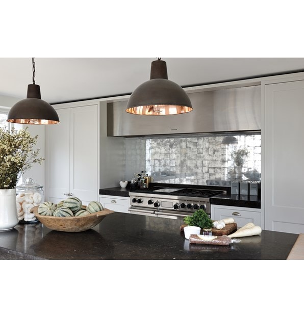 The Wolf 48" Dual Fuel Range 6 Burner Infrared Griddle (DF486G) shown with modern industrial backsplash alongside traditional kitchen cabinetry