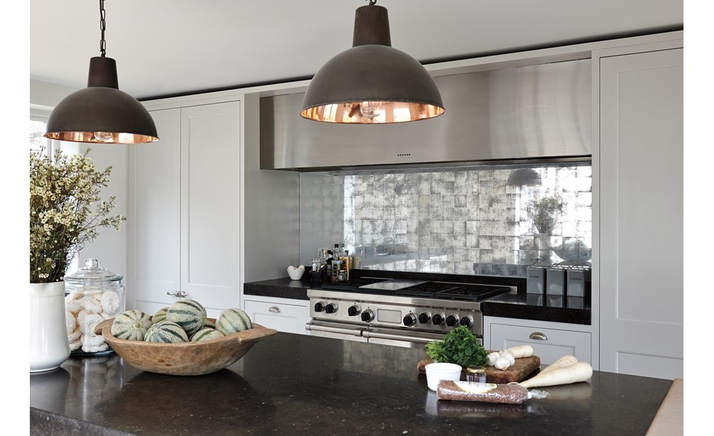 The Wolf 48" Dual Fuel Range 6 Burner Infrared Griddle (DF486G) shown with modern industrial backsplash alongside traditional kitchen cabinetry