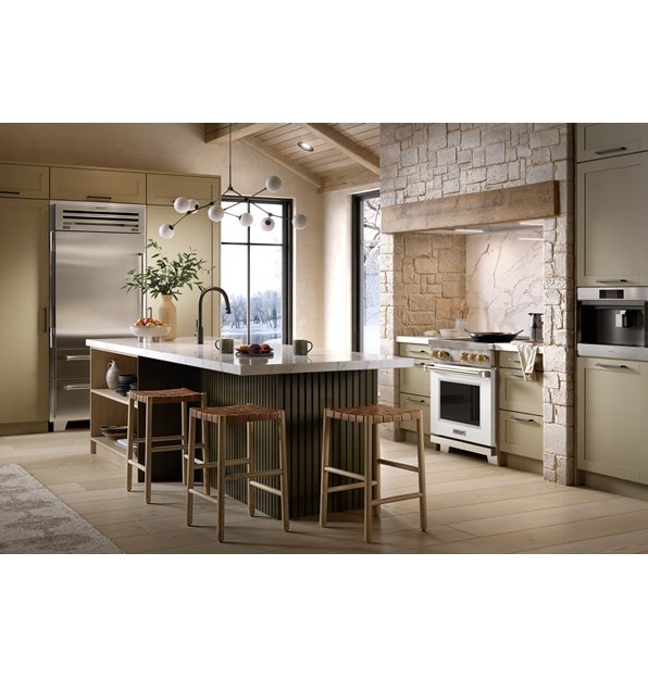 Wolf 30 Inch Professional Induction Range featuring white accent oven door with brushed brass knobs shown in a Nordic chalet kitchen design.