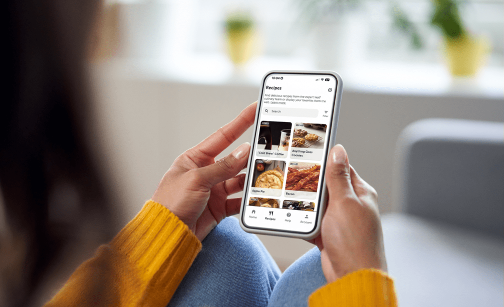A woman viewing recipes on the Sub-Zero Group Owner's App to use with her luxury Sub-Zero, Wolf, and Cove appliances.