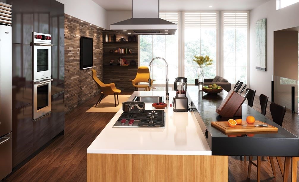 The Wolf 36" Professional Gas Cooktop (CG365P/S) displayed in large center island surrounded by an array of rich earthy tones and textures