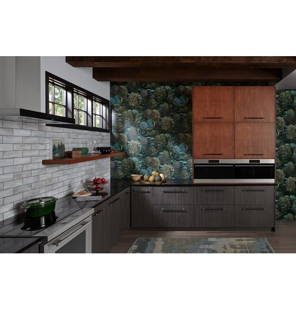 Two built-in Wolf Appliances in a colorful kitchen with green wallpaper, brown cabinetry, and a Wolf Ventiliation System.