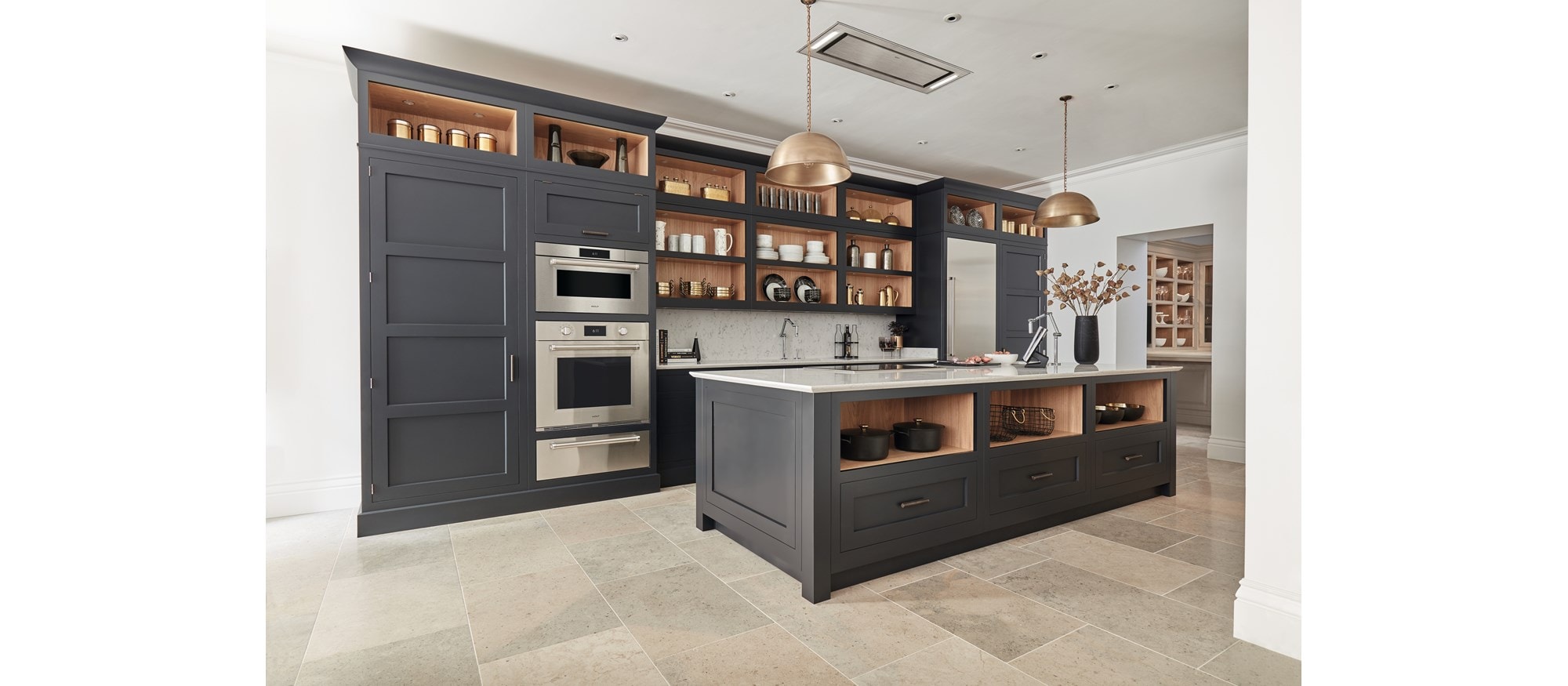 Horno de vapor con convección profesional de la serie M de 30" Wolf (CSO3050PM/S/P) instalados junto a gabinetes personalizados altos de color gris mate en cocina de baldosas de piedra