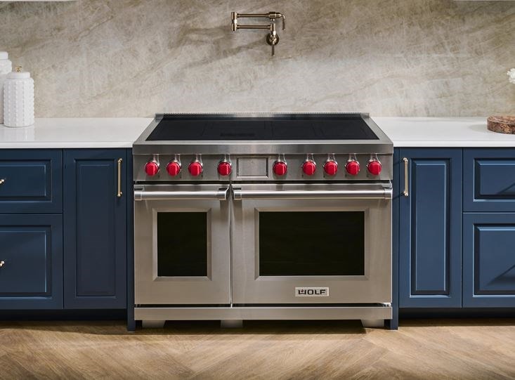 The new Professional Induction Range featuring the iconic red knobs for superior control from Wolf Appliances.