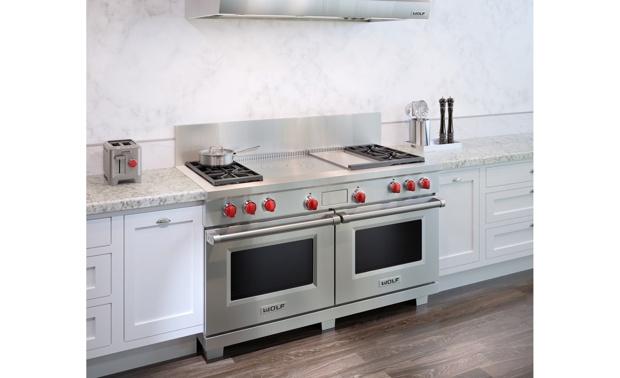 The Wolf 60" Dual Fuel Range 4 Burner Infrared Griddle French Top (DF604GF) shown with granite counter tops and country kitchen cabinets.
