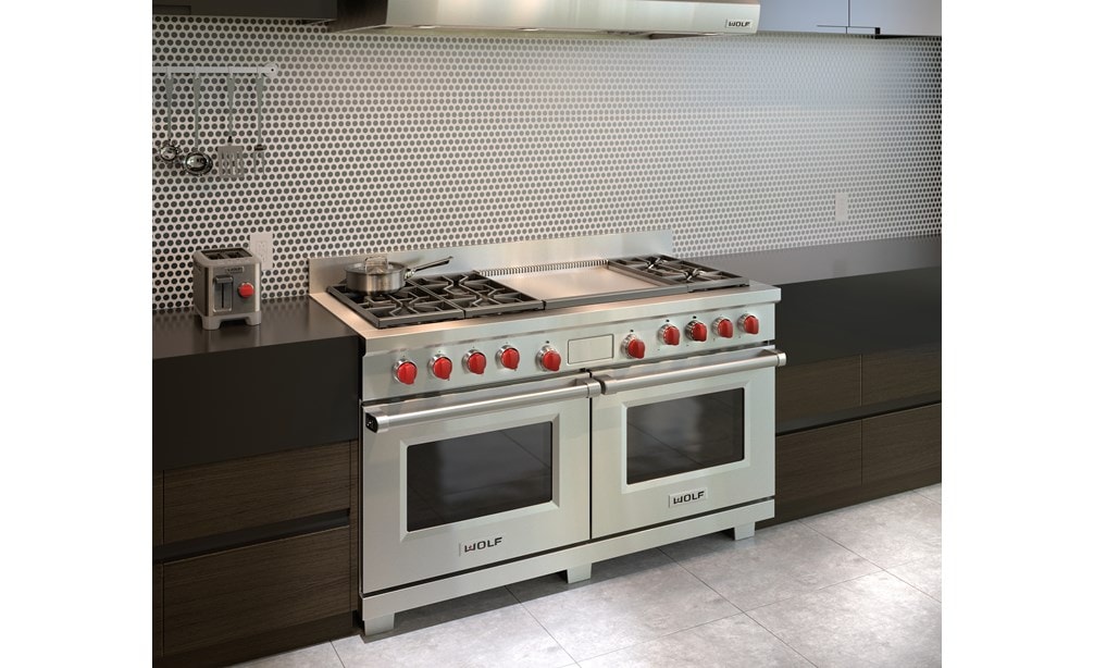 Wolf 60" Dual Fuel Range 6 Burner Infrared Dual Griddle (DF606DG) shown with modern chrome backsplash centered between glossy countertops
